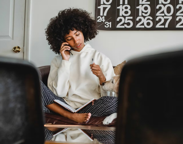 person talking on the phone while sitting on the floor
